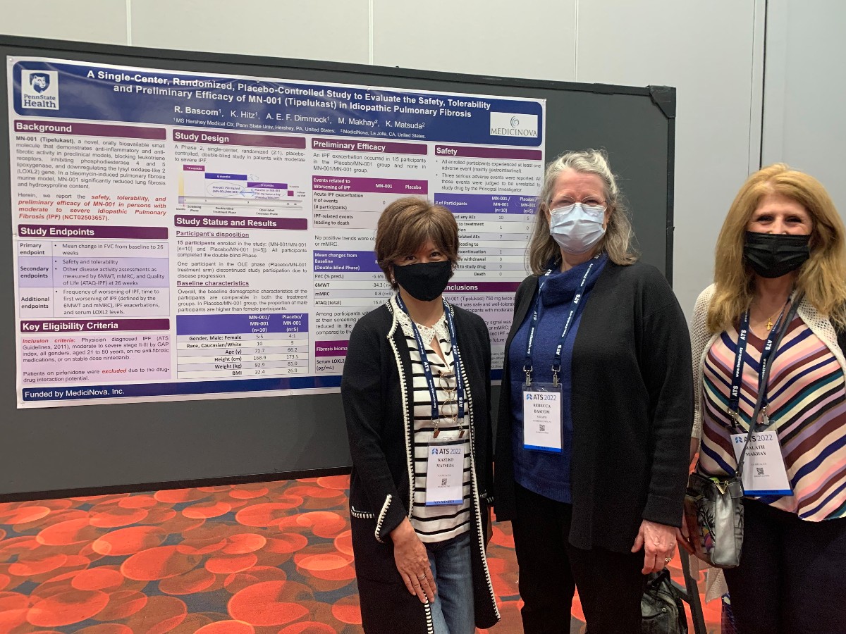Rebecca Bascom and two colleagues pose for a photo in front of a poster board. They are wearing masks.