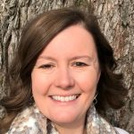 Head shot of Jennifer Basom standing in front of a tree