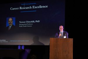 Vernon Chinchilli stands at a podium during the research and innovation awards ceremony.