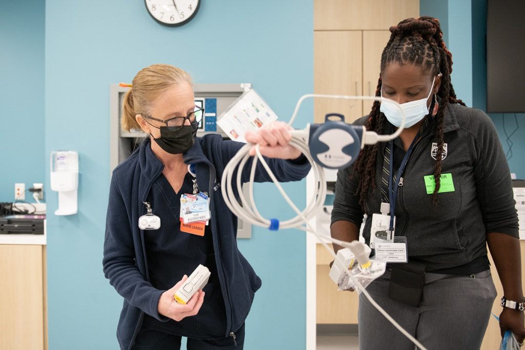 Susan McDonald, left, ICU nurse educator, holds a loop of cable as she and Adina Reno from Phillips set up cardiac monitors in the intensive care unit at Lancaster Medical Center