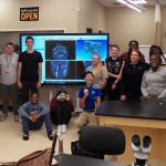 Marc Levine, Thomas Brouse and Milton Hershey School students pose for a photo while holding facial bone they 3D-printed.
