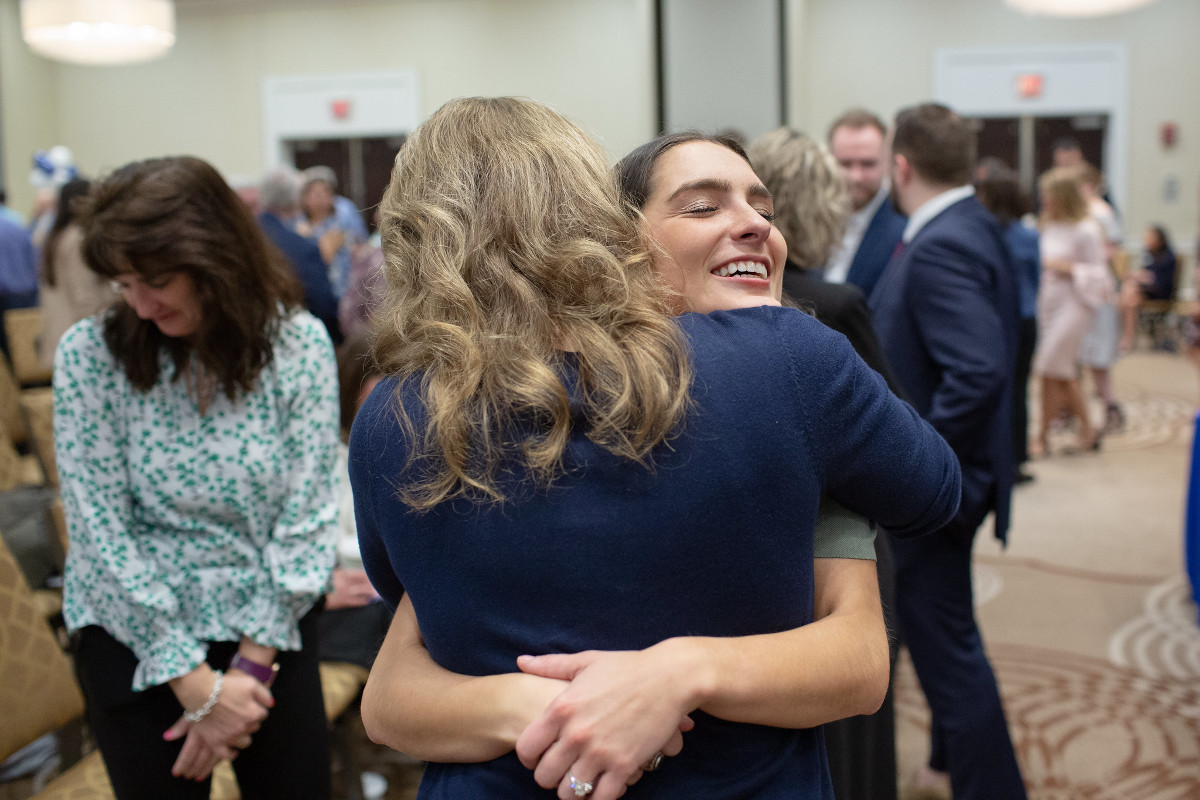 Two women embrace