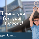 A young boy holds a trophy high in the air. The backdrop is a blurred photo of Penn State Health Children's Hospital with the words "Thank you for your support!" are placed. The Children's Hospital and CMN logos are at the bottom.