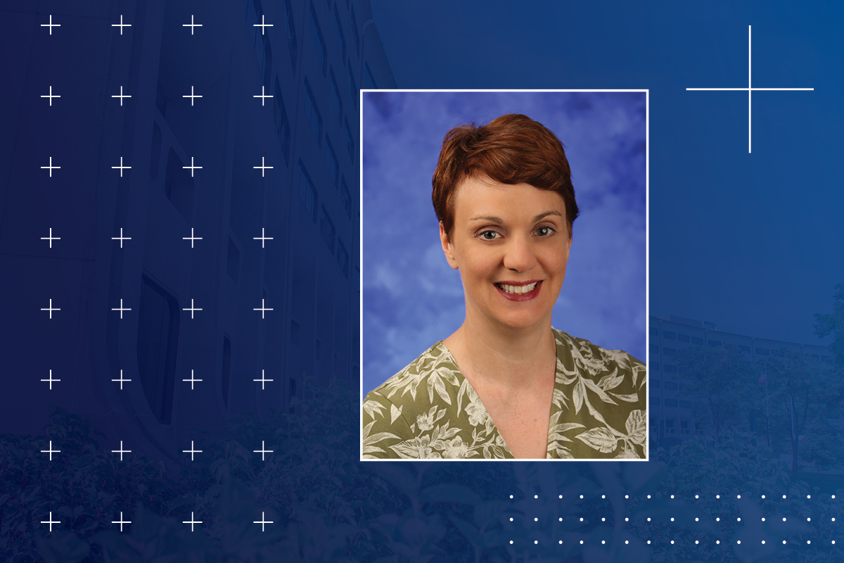 A head and shoulders professional portrait of Kirsteen Browning against a faded background image of Penn State College of Medicine.