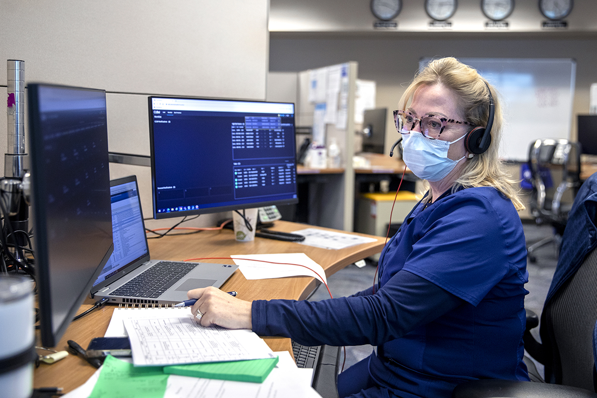 Susan Richwine, a registered nurse in Penn State Health’s Virtual Intensive Care Unit, sits at a desk at Penn State Health Milton S. Hershey Medical Center viewing multiple computer screens that allow her remotely to monitor the conditions of patients in intensive care.