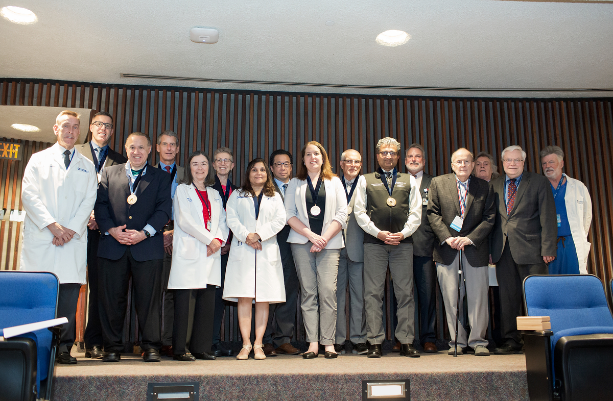 A group of faculty members who have been appointed to endowed positions at Penn State College of Medicine since 2021 gather on a stage for a group photo prior to the Spring 2023 Dean’s Lecture on Tuesday, May 9.