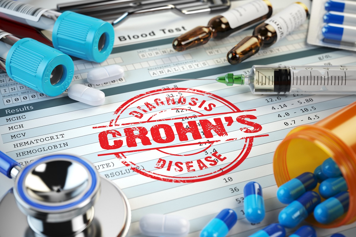Graphic on Crohn’s disease diagnosis. Stamp, stethoscope, syringe, blood test and pills on the clipboard with medical report.