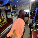 The interior of an ambulance is decorated for a birthday.
