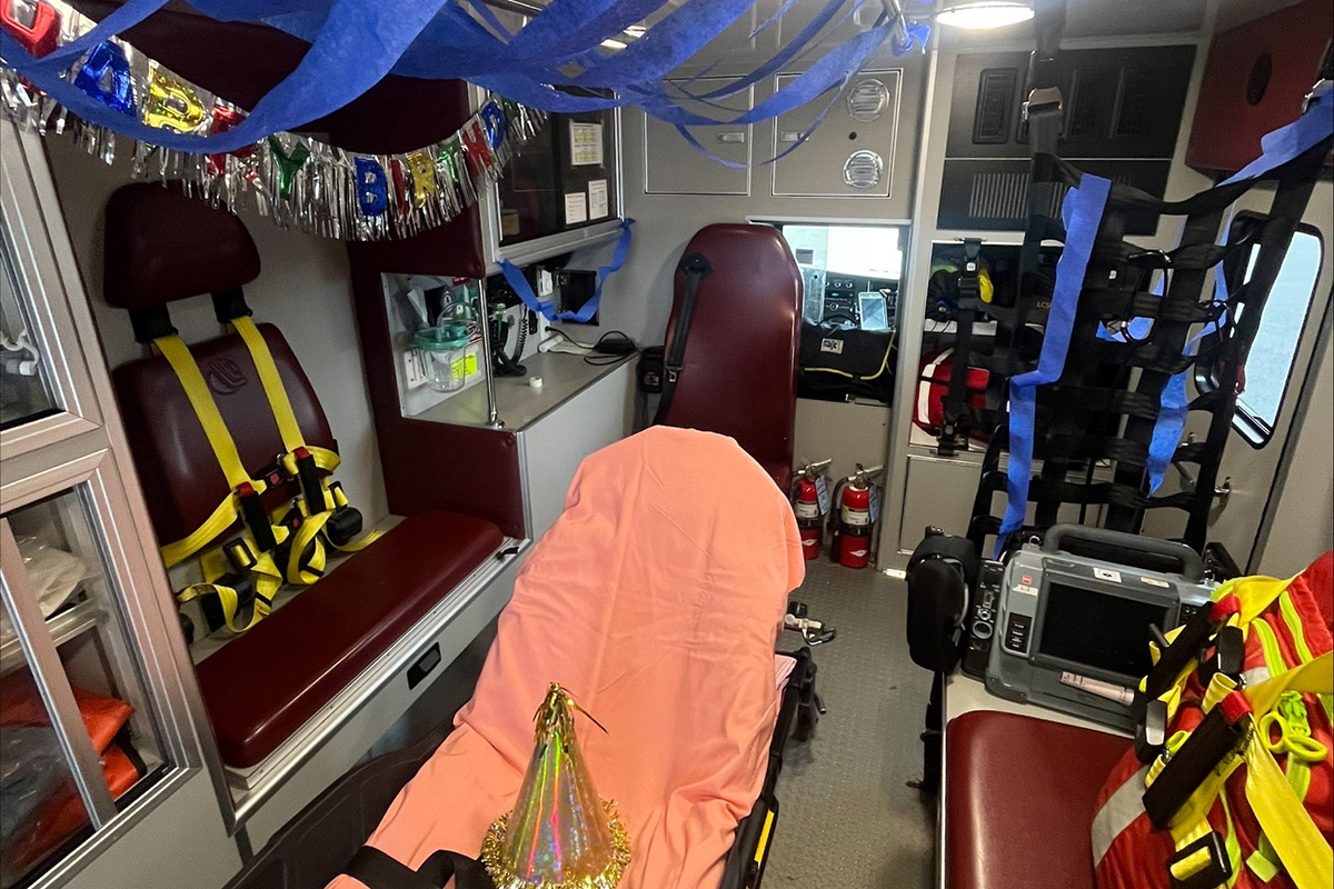 The interior of an ambulance is decorated for a birthday.