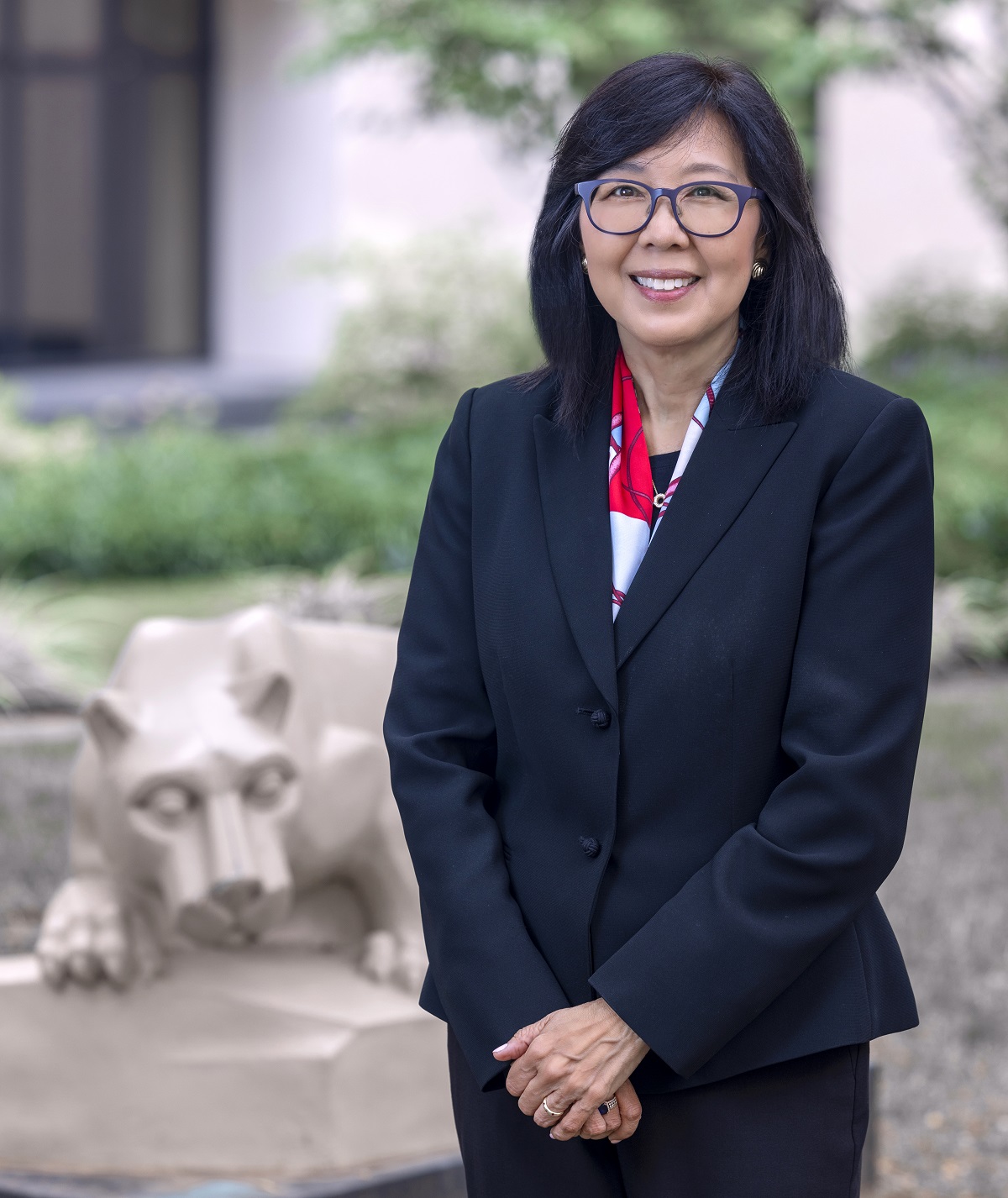 Karen Kim, MD, poses in front of the nittany lion statue in the courtyard outside Penn State College of Medicine.