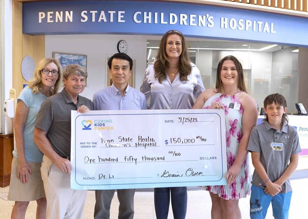 Six people stand behind a presentation check made out to Penn State Health Children's Hospital for $150,000.