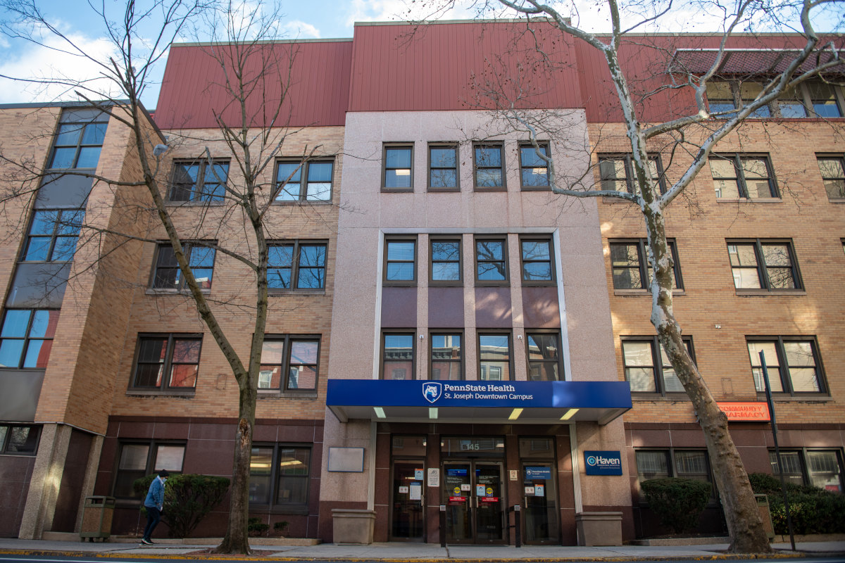 An exterior shot of the Penn State Health St. Joseph Downtown Campus, a building with brick and windows, and an awning with the Penn State Health St. Joseph logo.