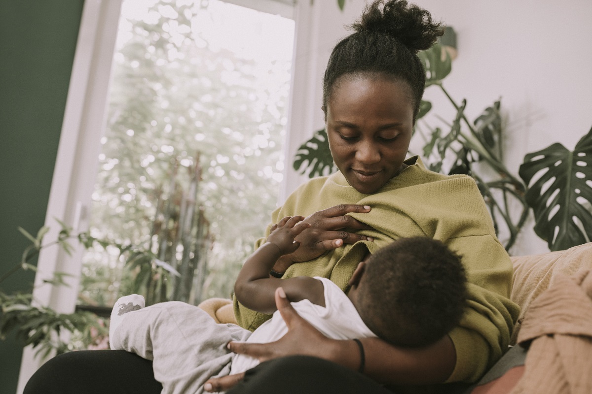 A mother breast feeds her baby.