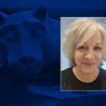 Headshot of Kimberly Raudabaugh, smiling on a background image of the Penn State Nittany Lion.