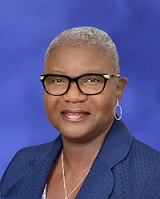 Professional portrait of Deborah Addo, president and COO, Penn State Health. She is wearing glasses, earrings, a necklace and a suit.
