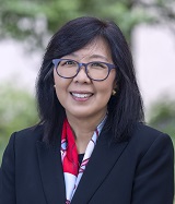 Professional portrait of Dr. Karen Kim, the new dean for Penn State College of Medicine. She is wearing a suit with a scarf and glasses.