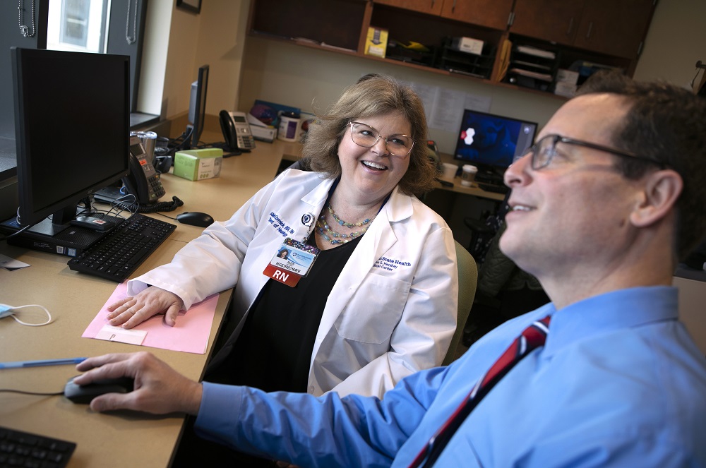 Aileen McCormick, left, a registered nurse with the department of Neurology at Penn State Health Milton S. Hershey Medical Center, talks with Dr. Gary Thomas on Thursday, March 2, 2023.