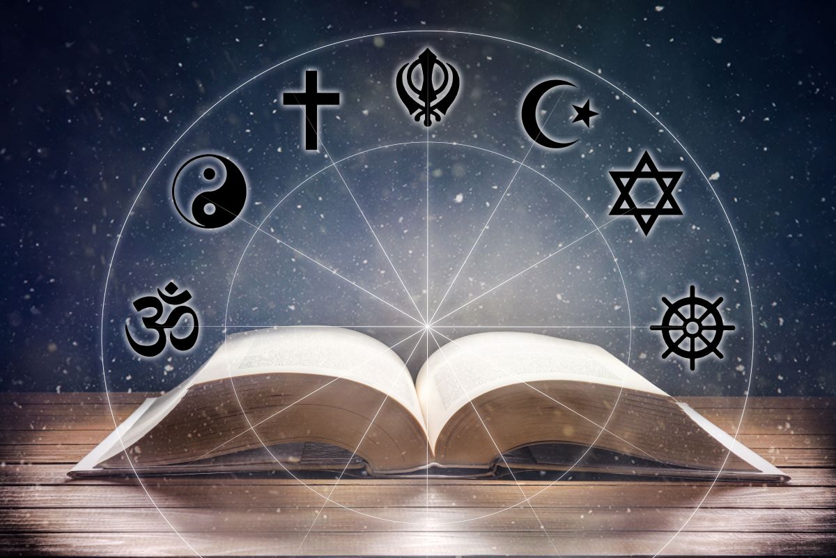 Book open to middle under a light from above. Overlaid, circle containing seven icons images representing the major religions of the world.