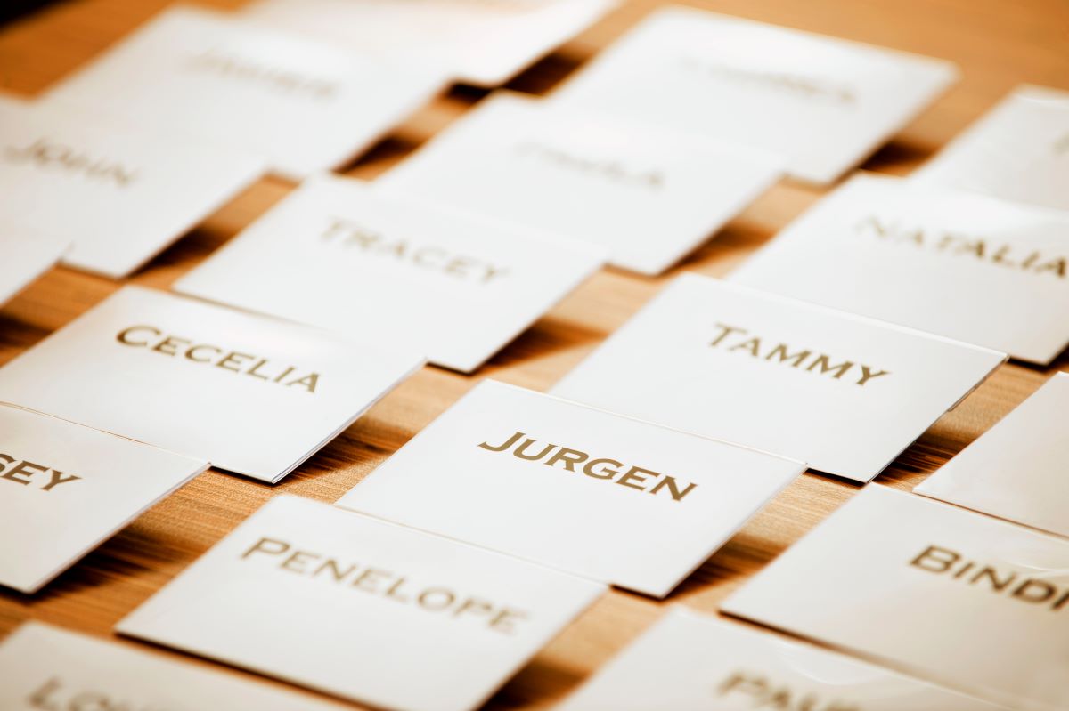 Name tags lined up on a wooden table, shown from an angle.