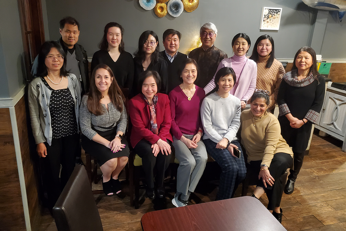Group photo of 14 people taking part in the Asian Physician and Professional Association Lunar New Year celebration.