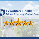 The Penn State Health Milton S. Hershey Medical Center logo is centered, with five stars below, with a photo of the medical center in the background.