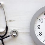 A stethoscope is shown next to a clock, illustrating the idea that missed medical appointments, called no-shows, affect everyone in the health system.