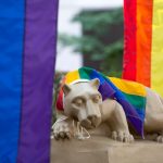 Rainbow pride flags surround the Nittany Lion.