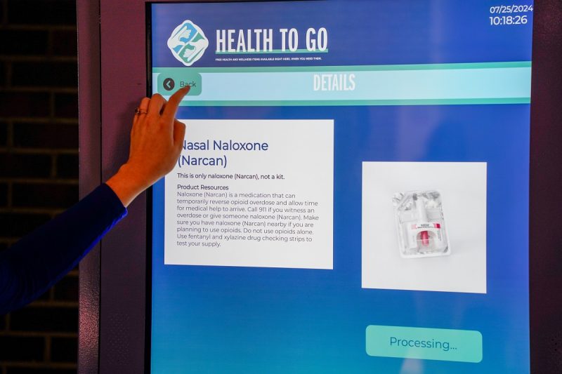 Photo shows an interactive vending machine that dispenses health care items