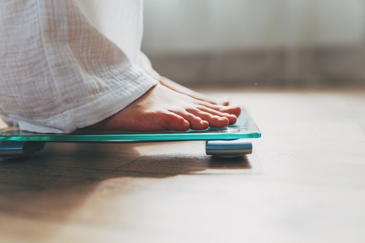 Feet standing on an electronic scale.