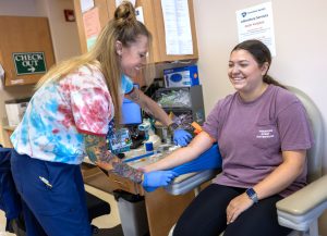 Jodi Bracken, a medical assistant at Penn State Health Medical Group - Cornerstone, prepares to draw blood from a patient during her appointment