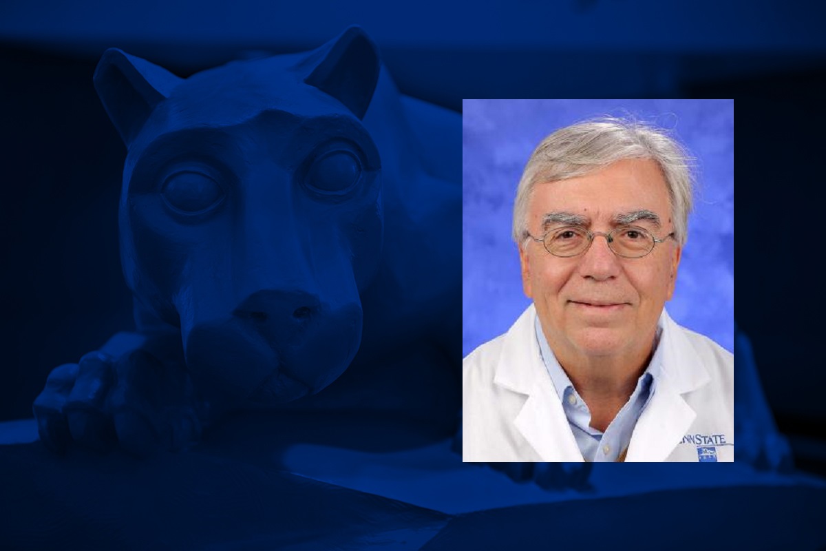 Photo shows a head shot of a man wearing glasses and a white doctor's coat overlaid on a blue graphic with a statue of a lion mascot