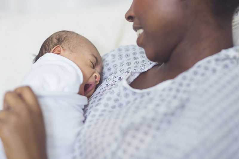 A baby lays on a mother's chest