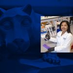 A photo of a woman wearing a white doctor's coat in a research lab