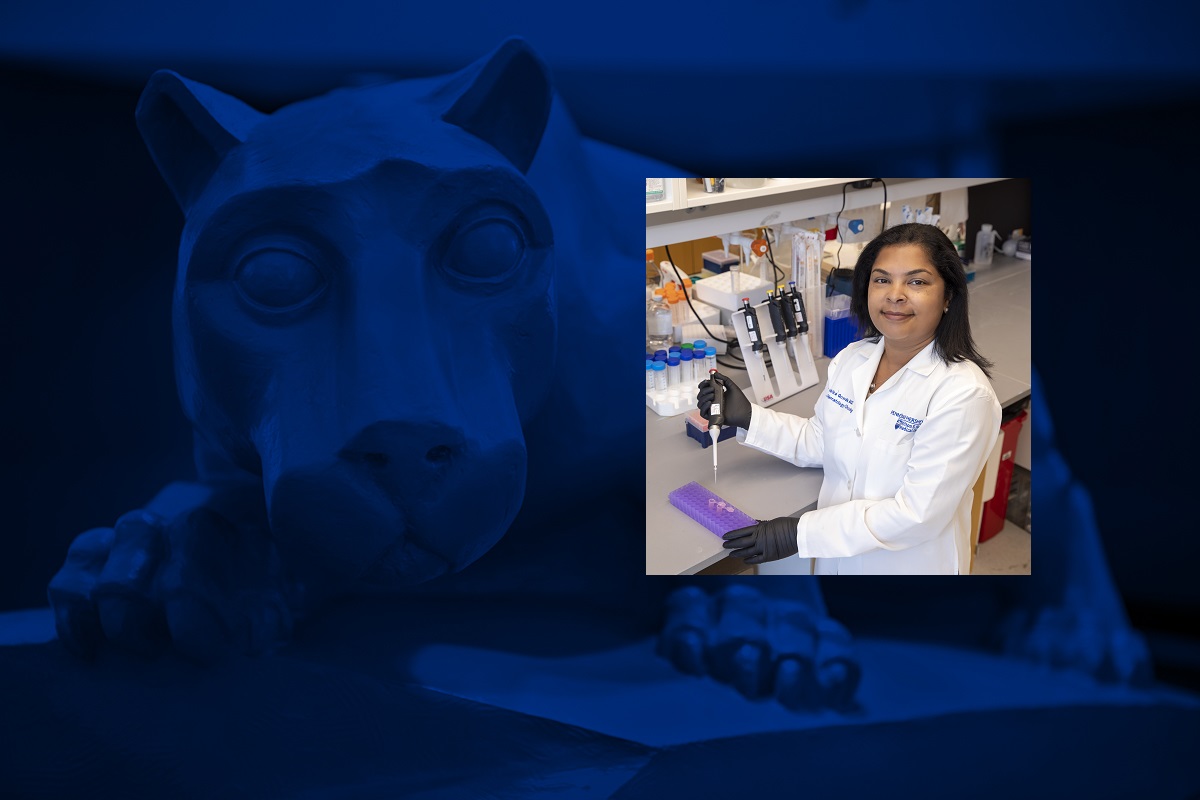 A photo of a woman wearing a white doctor's coat in a research lab