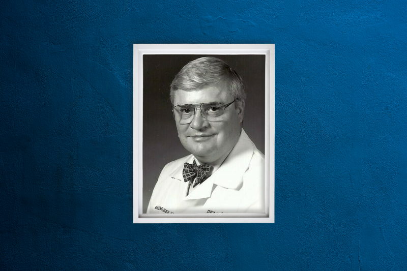 A professional headshot of Dr. Robert B. Greer, III, wearing a medical coat and bowtie