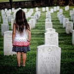 Child walking through cemetery