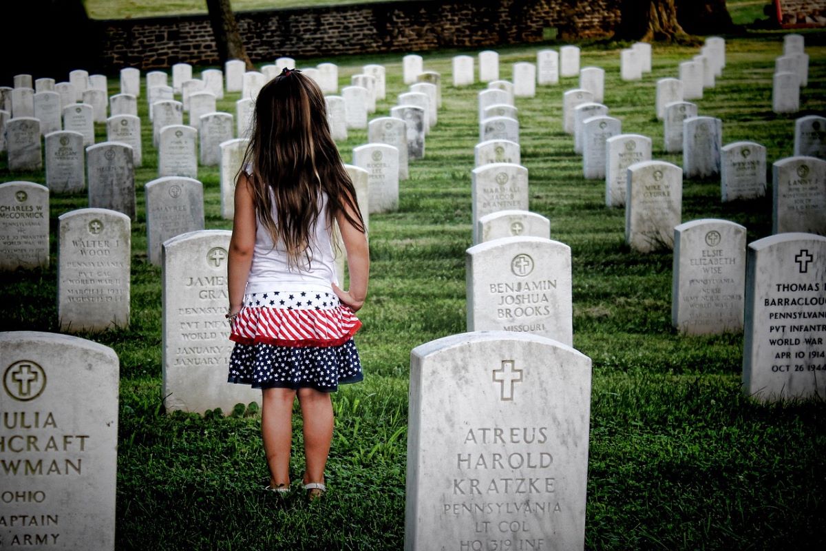 Child walking through cemetery