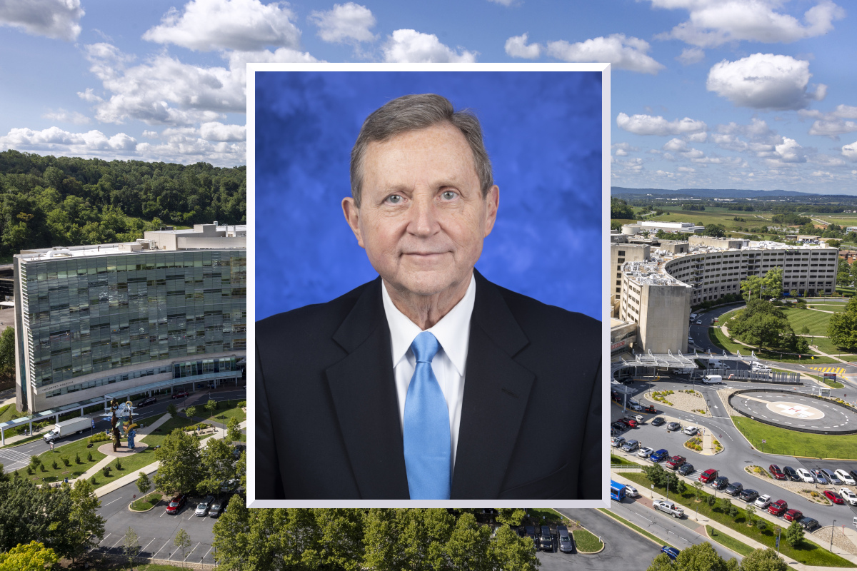A professional headshot photo of Dr. Robert Harbaugh wearing a suit and tie is superimposed over an image of Milton S. Hershey Medical Center.