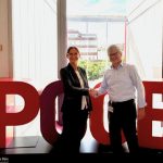 Two people standing next to each other and shaking hands.