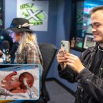 Side-by-side images show Sam Erikson as a premature infant receiving care in the NICU at Penn State Health Golisano Children’s Hospital and, years later, as an adult recording a video on his phone during the People’s Pay 4 Play event at a radio station studio.