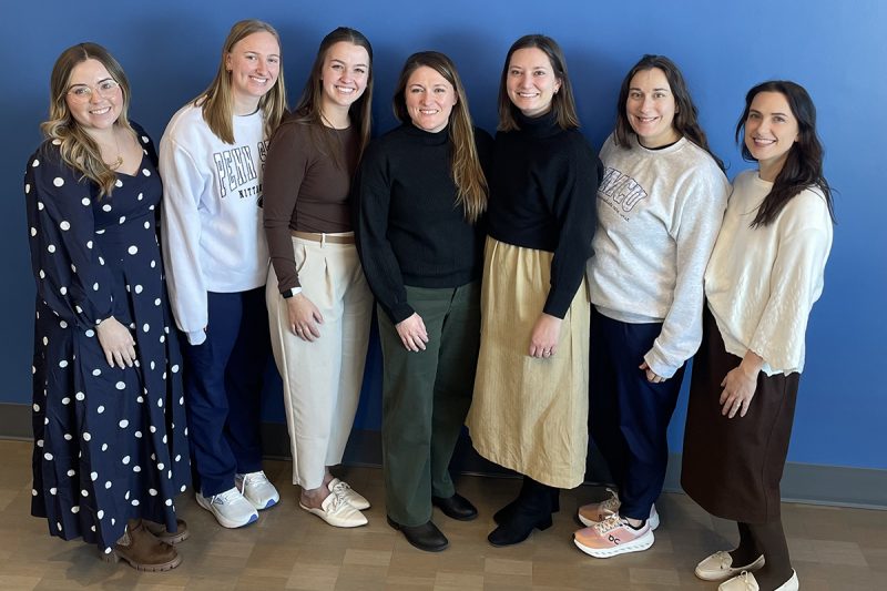 Seven members of the Pediatric Intermediate Care Unit at Golisano Children’s Hospital smile in a group photo.
