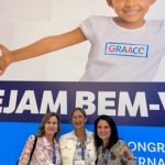 Three doctors stand together at a hospital
