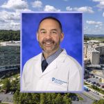 A professional photo of Donald Bucher wearing a clinical coat, superimposed over a photo of the Milton S. Hershey Medical Center campus.