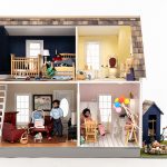 A dollhouse shows common household hazards in the bedroom, bathroom, living room, kitchen and backyard.