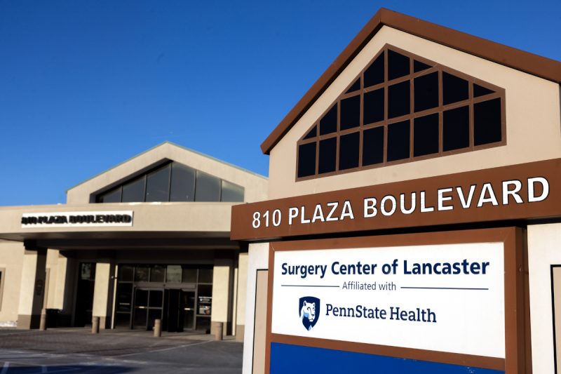 An external photo of Surgery Center of Lancaster, with a sign prominent in the foreground.