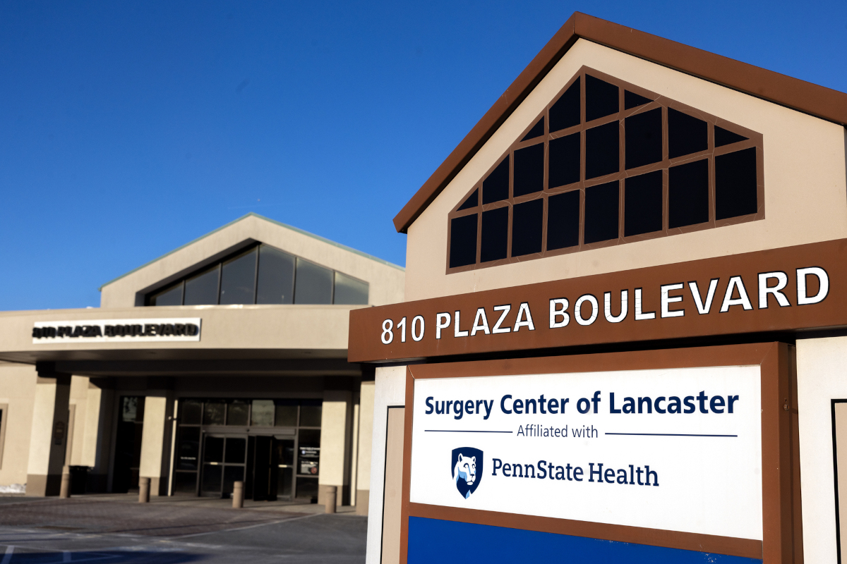 An external photo of Surgery Center of Lancaster, with a sign prominent in the foreground.