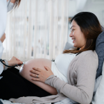 A pregnant woman consults with a doctor during a routine checkup.