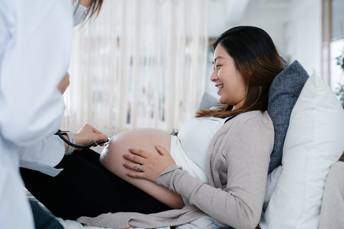 A pregnant woman consults with a doctor during a routine checkup.