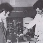 A black and white picture of two researchers working on an artificial half heart