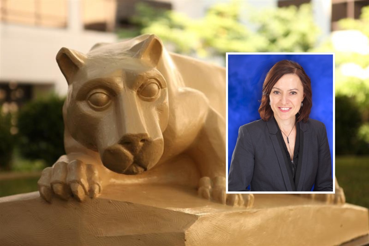 A nittany lion statue rests with its paws over a stone ledge on a college campus, with greenery and buildings blurred in the background. An inset headshot in the corner shows a woman with shoulder-length brown hair wearing a dark blazer and smiling against a blue backdrop.